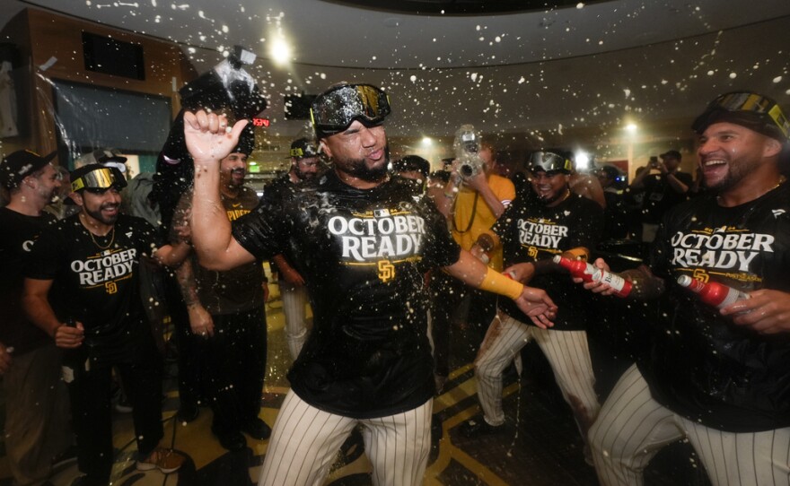 San Diego Padres players celebrate in the dugout after defeating the Atlanta Braves in Game 2 of an NL Wild Card Series baseball game Wednesday, Oct. 2, 2024, in San Diego.