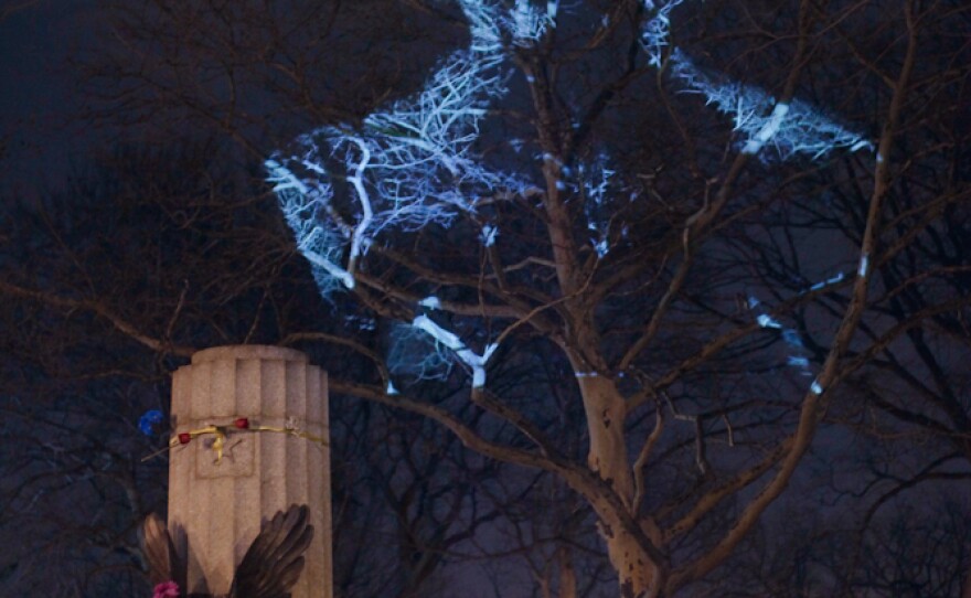 The Illuminator Art Collective used ashes and light to project the image of Snowden.