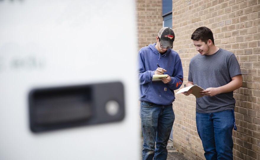 Tucker Bubacz and Joshua Hewitt fill out their pre-trip inspection sheets outside Williamsport High School in Williamsport, Md., on Monday, Oct. 17, 2022.