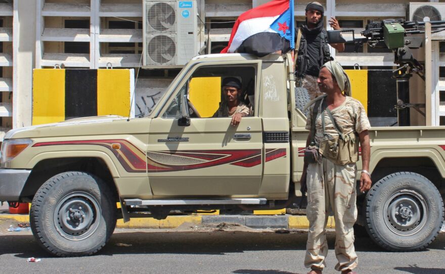 Separatist fighters fly the old, pre-unification flag of South Yemen above their pickup as they patrol Aden on Tuesday. Yemen's internationally recognized government has accused the separatist Southern Transitional Council of orchestrating a coup as it has moved closer to controlling the government's de facto capital.