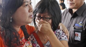 A relative of AirAsia flight QZ8501 passengers weeps as she waits for the latest news on the missing jetliner at Juanda International Airport in Surabaya, East Java, Indonesia, Dec. 28, 2014.