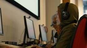 Pictured: woman with headphones at Senior Planet in New York City. The program draws on common sense, expert opinions, and the universal standards of journalism to teach the media literacy skills needed to dissect breaking news, evaluate partisan content, and utilize critical thinking before adopting radical stances. 