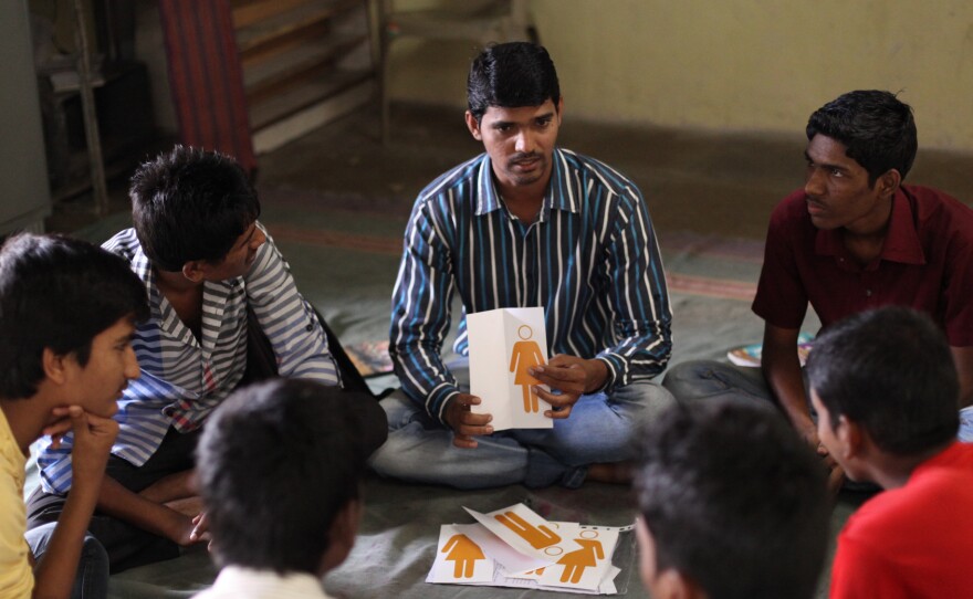 It's a three-hour class, once a week for 15 weeks. A mentor (center) leads the teen boys in a discussion.