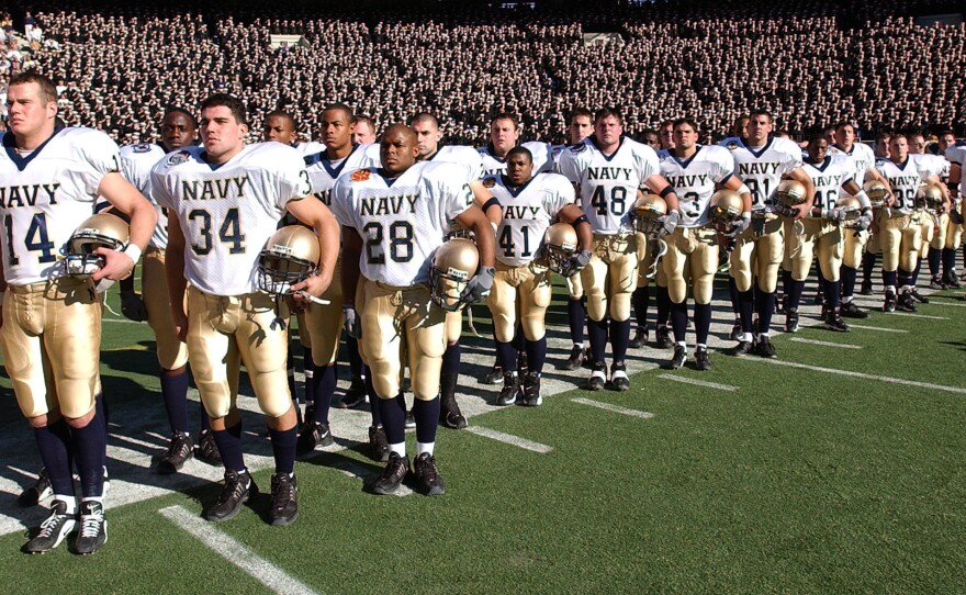 Navy players await the start of their annual game against Army, on Dec. 1, 2001.