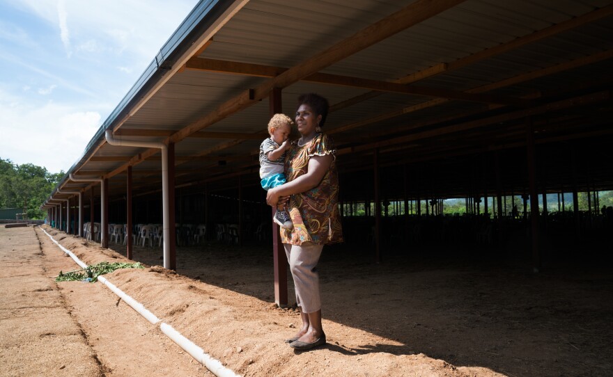 Faith Kimala, a 29-year-old flight attendant, holds her son at the church she attends in a Port Moresby suburb. Kimala contacted Linda Tule for help in leaving a violent marriage. Tule wrote a legal document called a preventive order, under which her husband will pay a fine or go to jail if he hits Kimala again. Tule advised Kimala to stay with her husband until she believes she's in danger again.