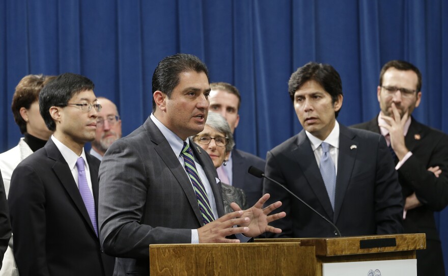 State Sen. Ben Hueso, D-San Diego, second from left, discusses his proposed bill to fund lawyers for immigrants in deportation proceedings, during a news conference at the Capitol in Sacramento, Dec. 5, 2016.