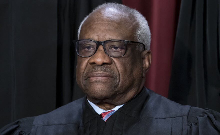 Associate Justice Clarence Thomas joins other members of the Supreme Court as they pose for a new group portrait at the Supreme Court building in Washington on Oct. 7, 2022.