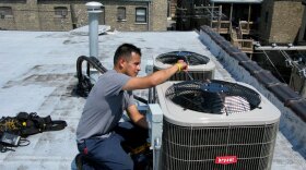 Eric Rebolledo, a repairman for AllTemp heating and air conditioning in Chicago, works on an air-conditioning unit on the roof of an apartment building. "I don't remember it being this hot for at least 10 years that I can recall," he says. "This is unusual, man, so it's gonna create some havoc with the air-conditioning  systems."