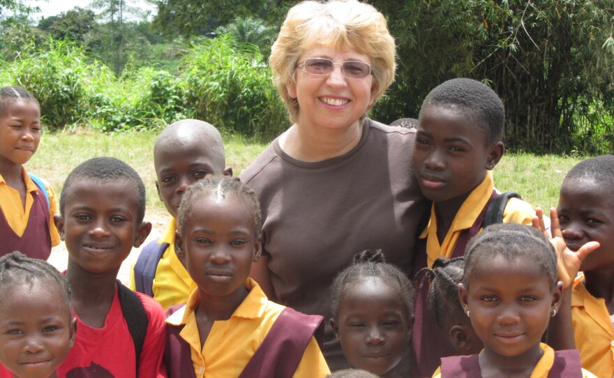 This Oct. 7, 2013, photo provided by Jeremy Writebol, shows his mother, Nancy Writebol, with children in Liberia. Writebol is one of two Americans working for a missionary group in Liberia that have been diagnosed with Ebola. AP Photo/Courtesy Jeremy Writebol