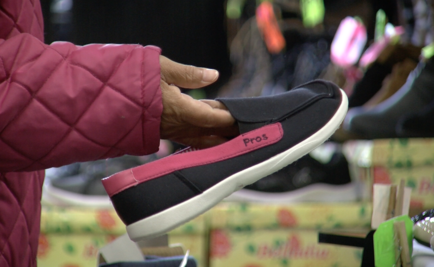 Mexican shopper Delia Frasco looks at shoes at Carolin Shoes Inc., Feb. 20, 2017.