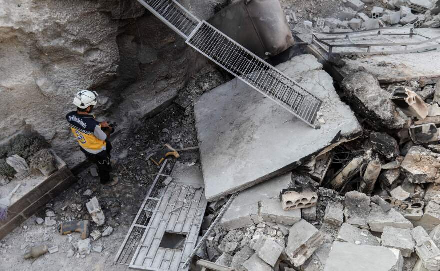 A member of the Syrian Civil Defense, also known as the "White Helmets," walking through the wreckage of their center, which was destroyed Thursday by government forces in the town of al-Tamana in rebel-held Idlib province.