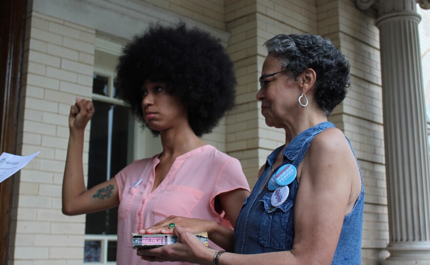Parker was sworn in as District 2 county commissioner on a copy of the <em>A</em><em>utobiography of Malcolm X</em>, next to their mother.