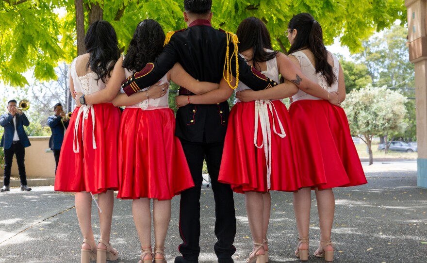 Kevin and his maids of honor pose for a portrait outside the church while a band plays regional music for his birthday on June 17, 2023.