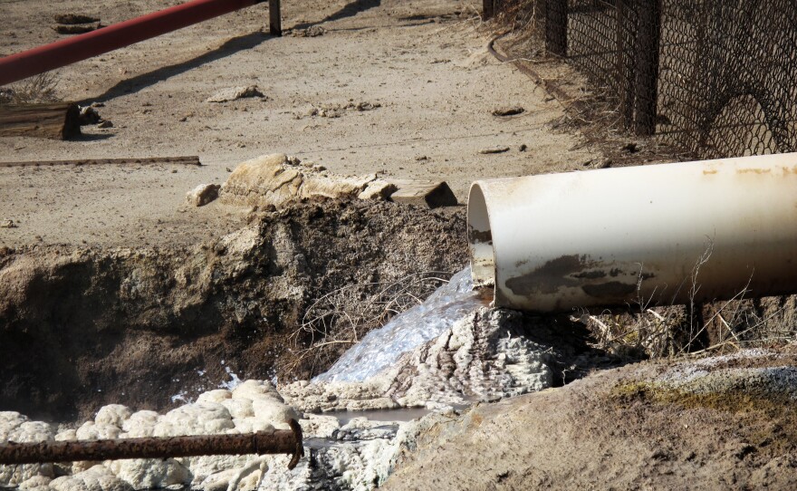 Internal EPA documents released to NPR show some EPA staffers have been trying to figure out what is in the wastewater released by oil companies. There are lots of chemicals. Some leave solid residues like these white and gray mounds. Danger signs near this outflow pipe warn that poisonous gas fumes from the water can cause respiratory irritation or suffocation.