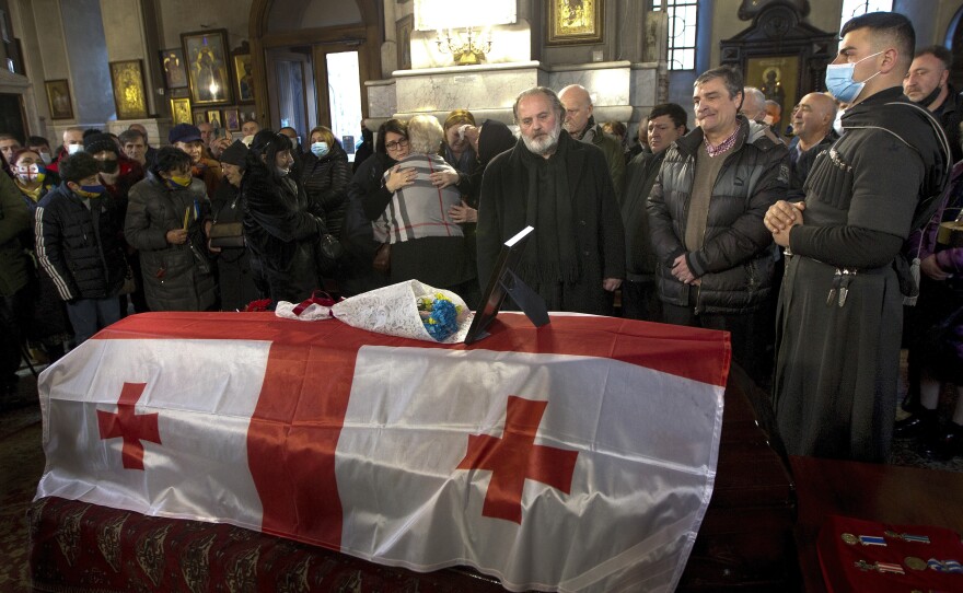 Russia's war in Ukraine has had an impact in other parts of the former Soviet Union. Here, relatives and friends mourn a  Georgian man killed when he went to fight on behalf of the Ukrainians. Russian troops have occupied part of Georgia since 2008. Russia has sent some of those troops from Georgia to Ukraine to fight there.