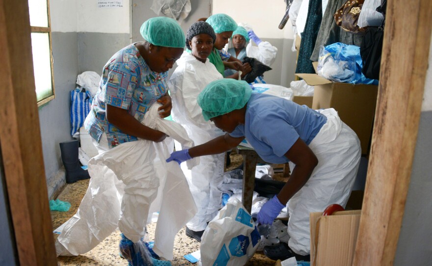 Medical workers at the John F. Kennedy Medical Center in Monrovia, Liberia, put on their protective suits before going to the high-risk area of the hospital, where Ebola patients are being treated, Sept. 3.