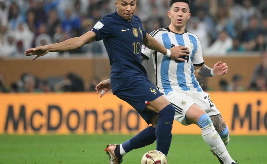 France's forward #10 Kylian Mbappe and Argentina's midfielder #24 Enzo Fernandez fight for the ball during the Qatar 2022 World Cup football final match between Argentina and France on December 18, 2022.