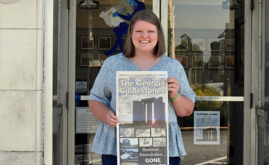 Rose Scoggins, editor of the local newspaper, with a special edition the paper put out after the monument was bombed earlier this month.