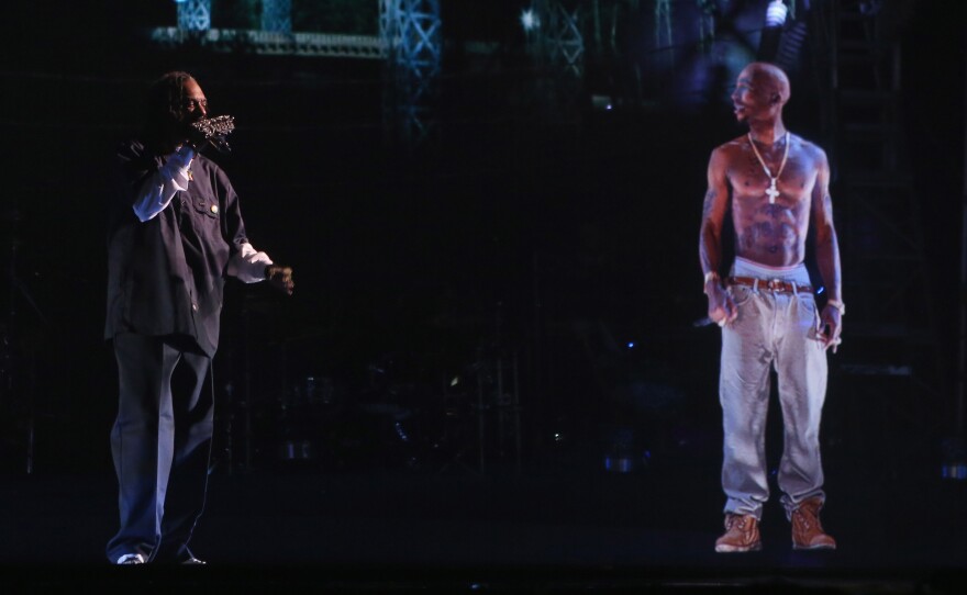 Snoop Dogg (left) performs with a hologram of the late rapper Tupac Shakur at the 2012 Coachella festival in Indio, Calif.