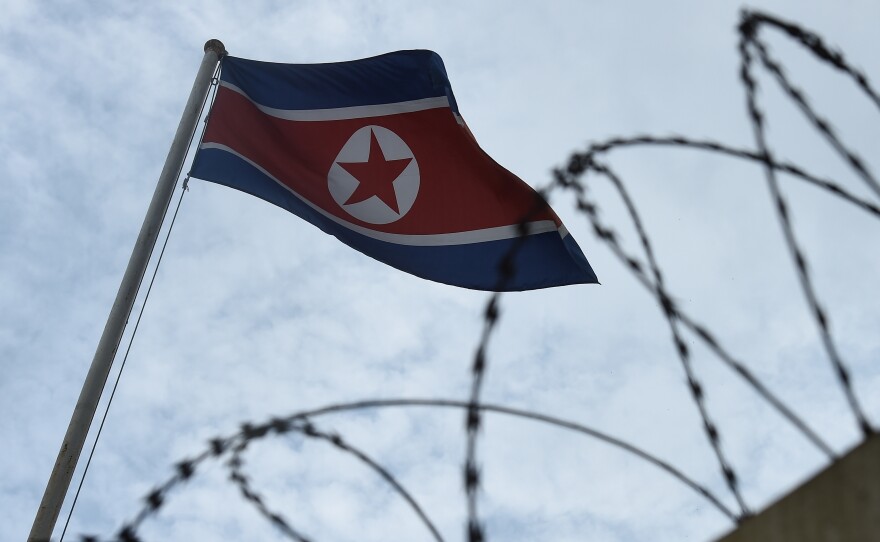 The North Korean flag flaps behind barbed wire at the North Korean Embassy on Sunday in Kuala Lumpur, Malaysia.