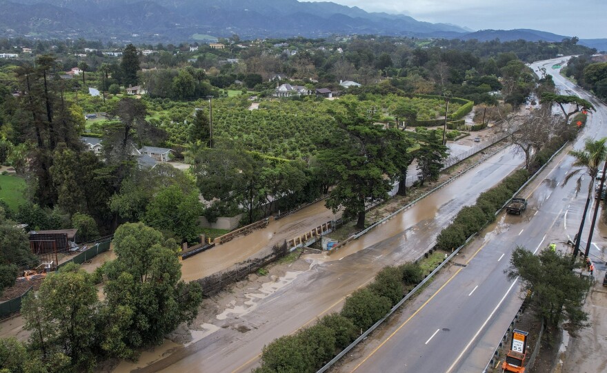 Water floods part of a road by the San Ysidro creek on Jameson Lane near the closed Highway 101 in Montecito, Calif., Jan. 10, 2023. Relentless storms from a series of atmospheric rivers have saturated the mountains and hillsides scarred from wildfires along much of California's coastline.