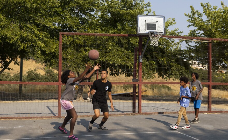Zohara, Jacob, Solomon and Abelli play basketball together before dinner.