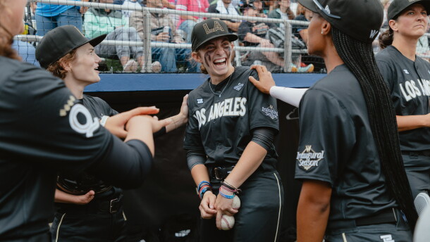 Brittany Apgar (from left), Maggie Foxx and Mo'ne Davis, of the Los Angeles Queens, joke around in the dugout prior to the start of the Women's Pro Baseball League's inaugural game in Springfield, Ill., on Saturday, Aug. 1.