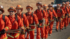 California inmate firefighters help with a controlled burn at Eastman Lake in Madera County in May 2021.
