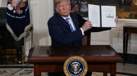 President Donald Trump signs a Presidential Memorandum on the Iran nuclear deal from the Diplomatic Reception Room of the White House, May 8, 2018.