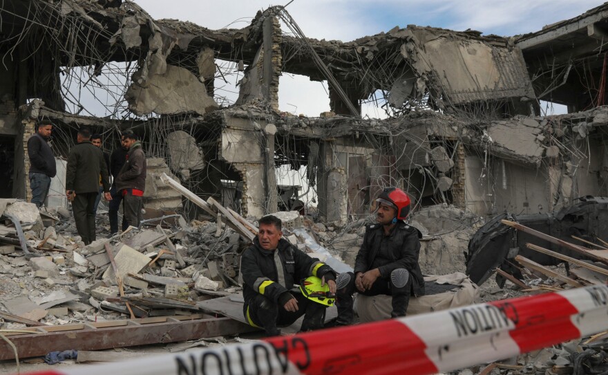 A civil defense team carries out search-and-rescue operations in a damaged building following a missile strike launched by Iran on Irbil, the capital of northern Iraq's Kurdish region, on Tuesday.