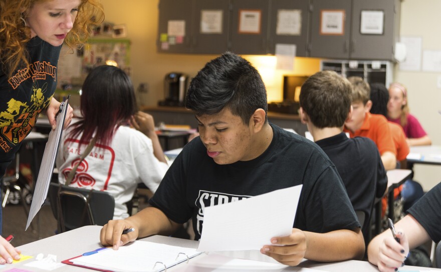 Jose talks with his English teacher Kathryn Remington about an assignment the class is working on.