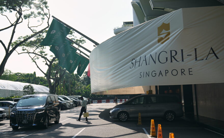 A man walk near the entrance of the Shangri-La Hotel, the venue for the International Institute for Strategic Studies (IISS) Shangri-La Dialogue, Asia's annual defense and security forum, in Singapore, Thursday, May 28, 2026.