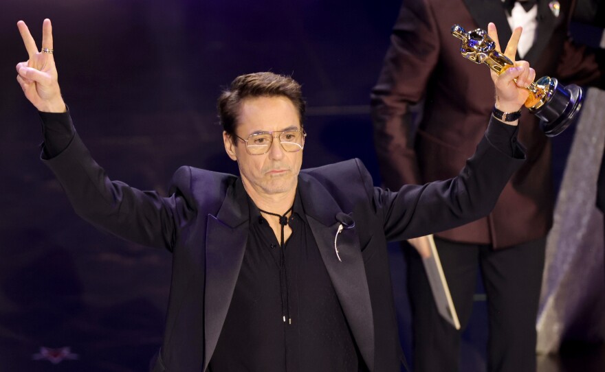 Robert Downey Jr. accepts the Oscar for best actor in a supporting role for <em>Oppenheimer.</em>