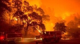 A fire truck moves position as flames from the Rocky fire approach near Clearlake, California, Aug. 2 2015. 