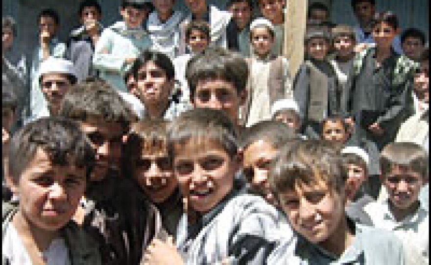Curious Afghan schoolboys gather in front of a U.S. Humvee in Elisay, a village in Kapisa province, about 50 miles north of Kabul. The U.S. military is working with the Afghan national security forces to oust insurgents from this lawless region.