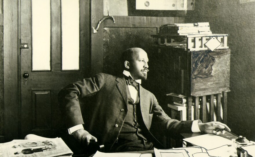 W.E.B. Du Bois seated at desk in office at Atlanta University, 1909.