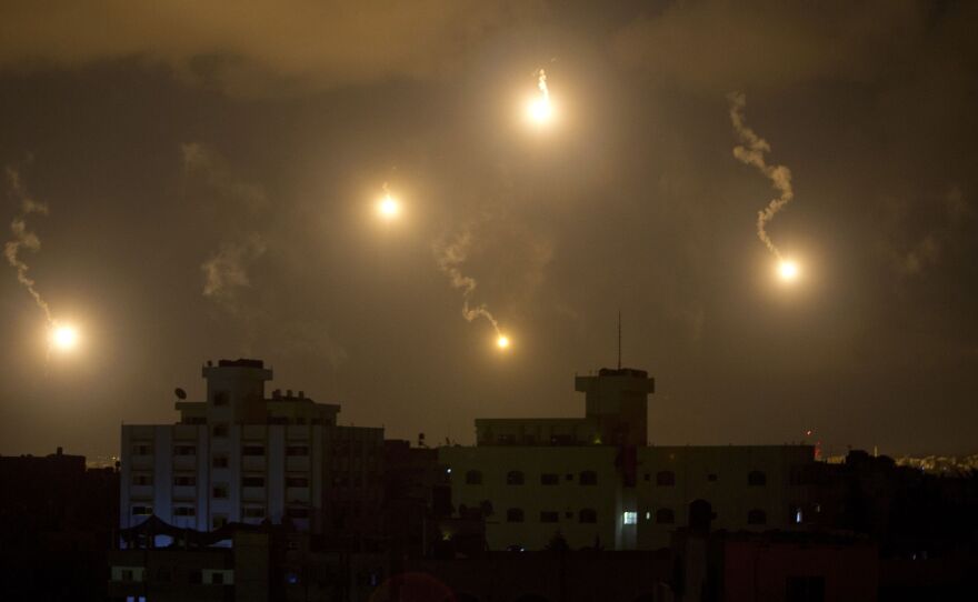 Israeli army flares illuminate the sky above the Gaza Strip on July 18. After waging an air campaign initially, Israel has sent ground troops into the territory.