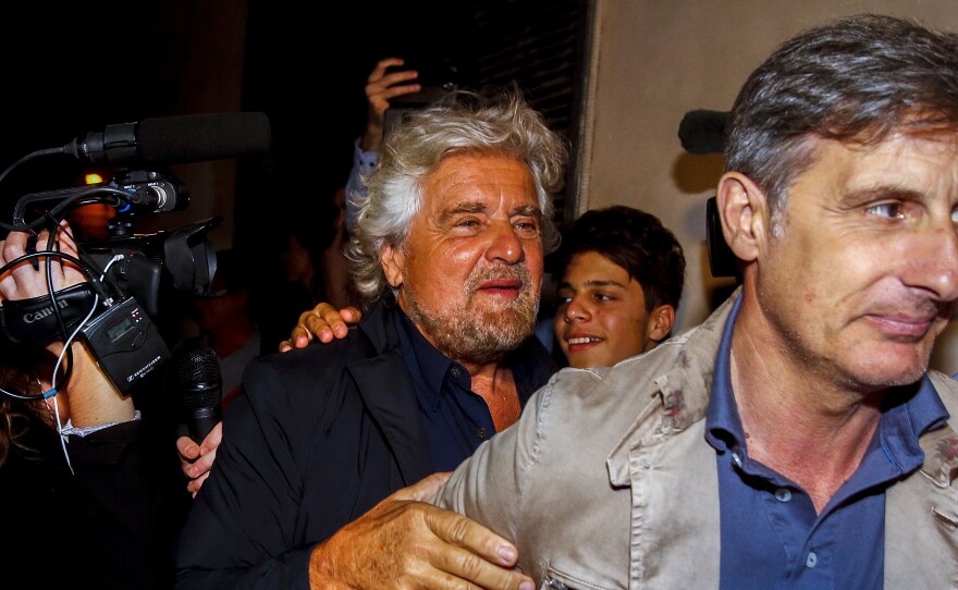 Beppe Grillo (left) arrives at a party in Rome June 27 after his anti-establishment 5 Star Movement triumphed in Italian mayoral runoff elections in 19 cities.