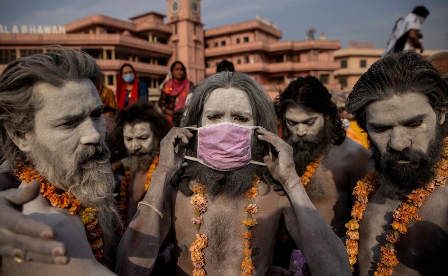 A Naga Sadhu, or Hindu holy man, wears a mask before the procession for taking a dip in the Ganges River during Shahi Snan at "Kumbh Mela," or the Pitcher Festival, amid the pandemic in Haridwar, India, on April 12, 2021.