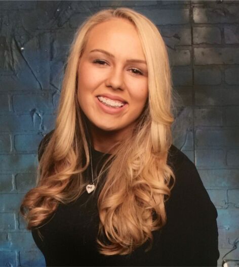 Alexandra Capelouto poses for her senior portrait in ____.