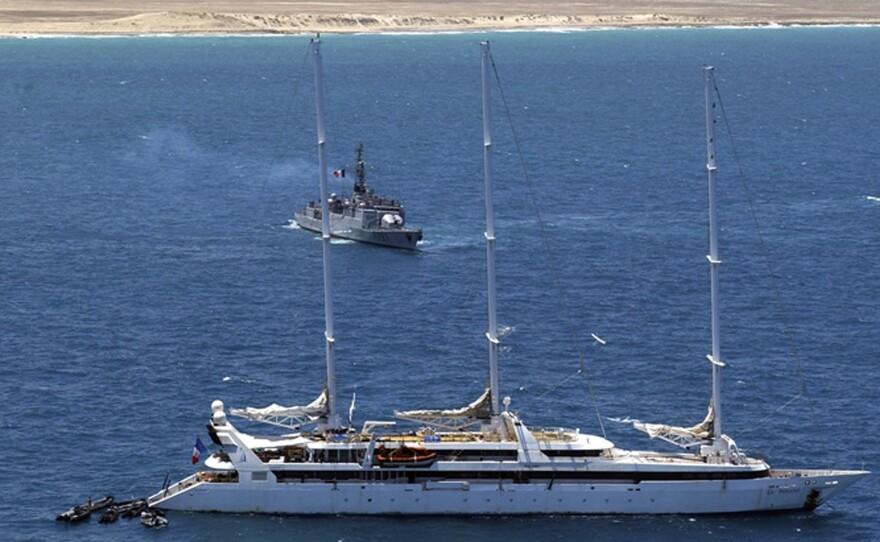 Zodiac commando boats arrive at the rear of the French luxury yacht Le Ponant, whose crew were held hostage by pirates. The French navy frigate Le Commandant Bouan is seen in the background, off Somalia's coast in April 2008.