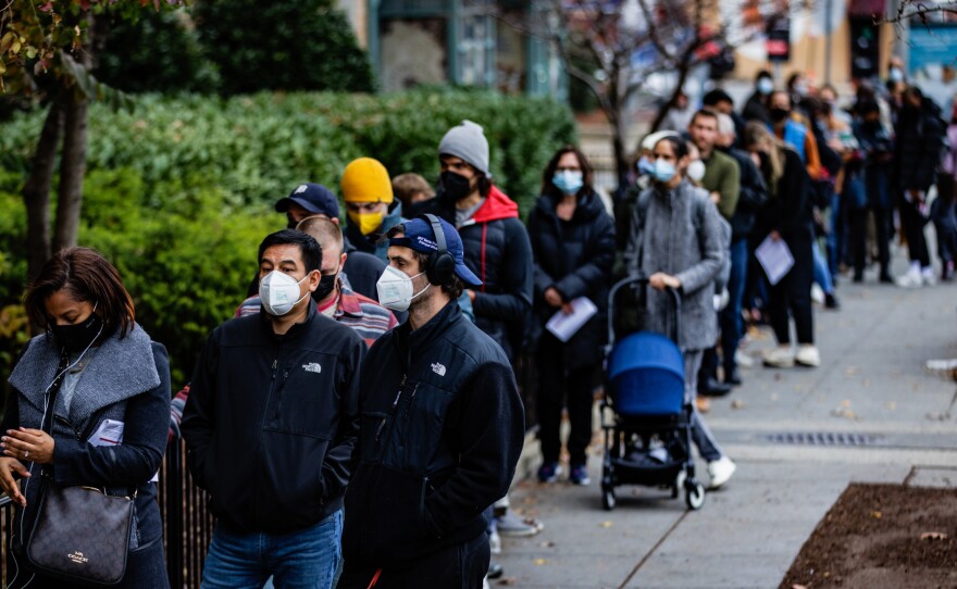 People line up outside of a free COVID-19 vaccination site on December 3, 2021 in Washington, DC. Many areas are stepping up vaccination and booster shots as more cases of the omicron variant are detected in the U.S.