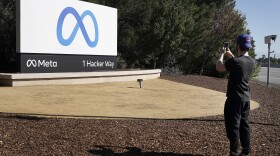 Facebook employee take a photo in front of new Meta Platforms Inc. sign outside the company headquarters in Menlo Park, Calif., Thursday, Oct. 28, 2021.