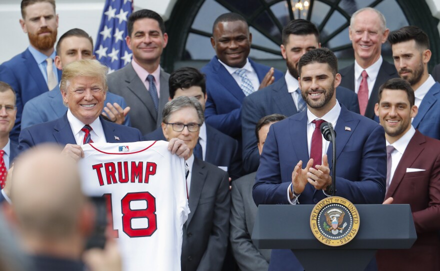 President Trump holds up a Red Sox team jersey that was presented to him by outfielder J.D. Martinez Thursday at the White House.