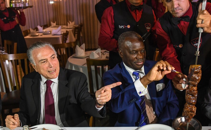 Brazil's President Michel Temer, left, held a dinner at a churrascaria in Brasilia to reassure ambassadors, such as Angola's Nelson Manuel Cosme, that the meat their countries are buying is of high quality.