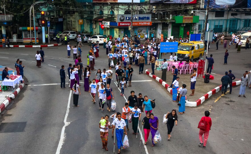 Members of the visually-impaired community, volunteers, local organizations and the Myanmar Red Cross Society participate in the 2017 White Cane Day walk in downtown Yangon. Yangon, Myanmar.