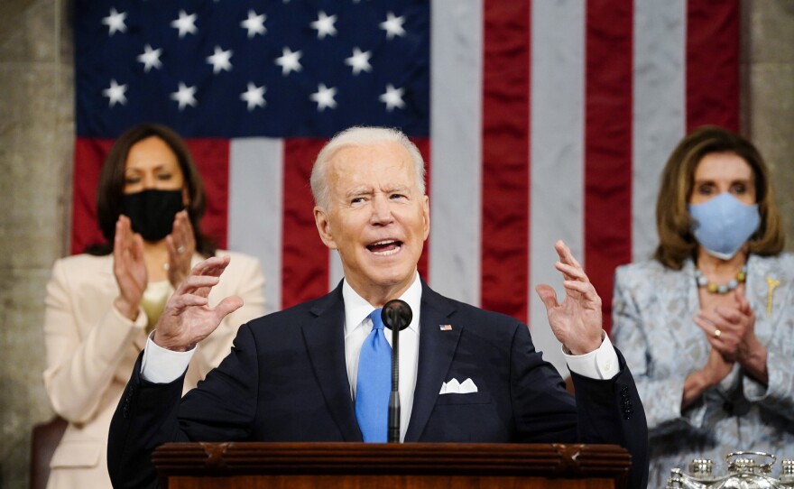 President Joe Biden addresses a joint session of Congress on April 28, 2021 as Vice President Kamala Harris, left, and House Speaker Nancy Pelosi of Calif., applaud.