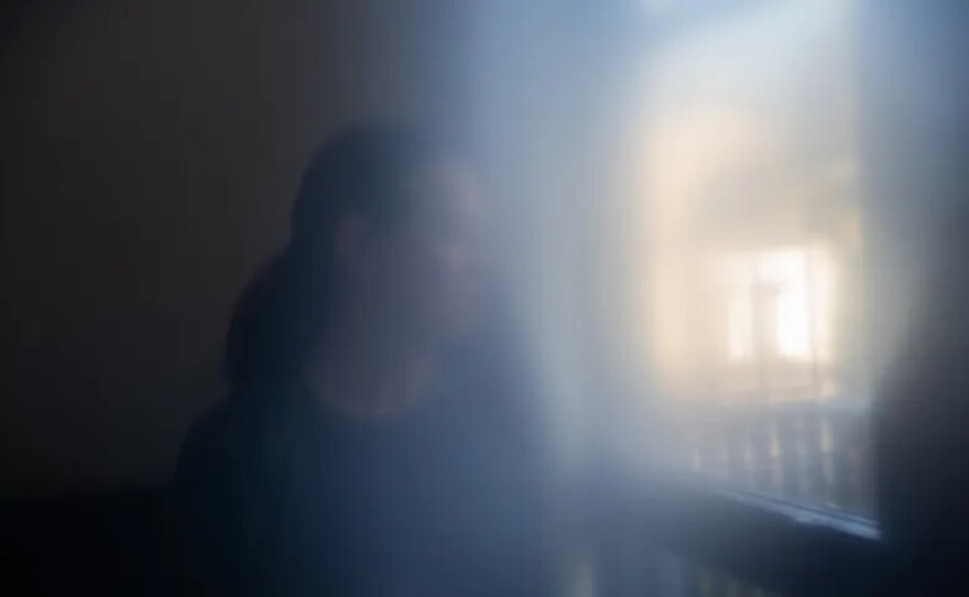 C.M., who prefers to not use her name, sits in her bedroom at a transitional home provided through CARE Court after receiving treatment for schizophrenia in Oakland on Dec. 1, 2025. She now lives in a single-occupancy room and is preparing to begin classes at Chabot College in January.