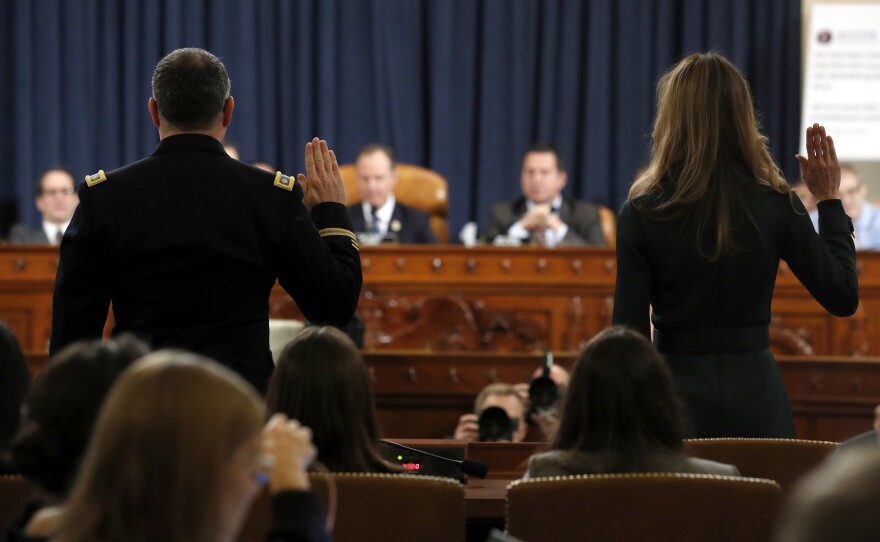 Jennifer Williams (right) and Lt. Col. Alexander Vindman are sworn in to testify before the House Intelligence Committee on Capitol Hill on Tuesday.
