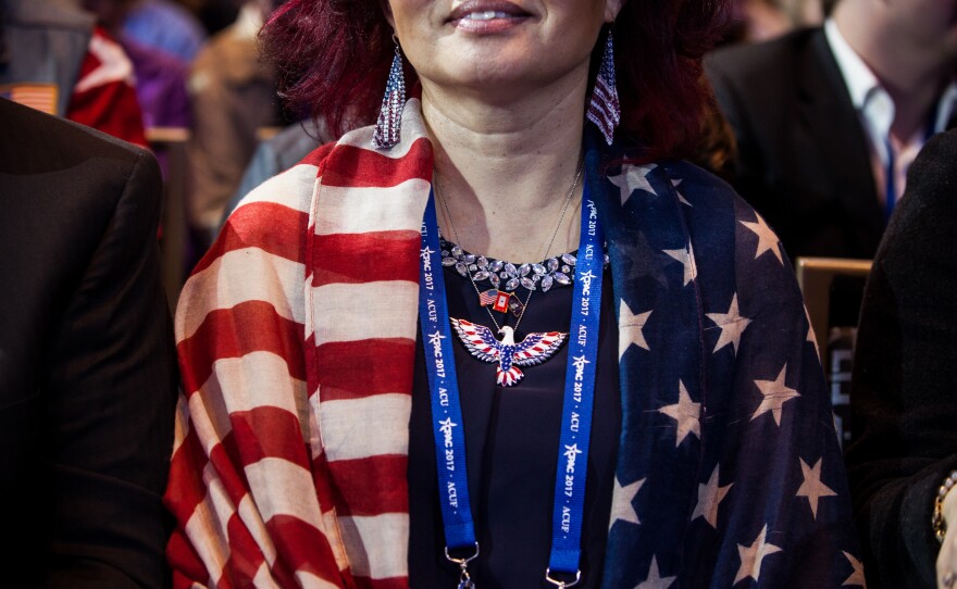 Yong Saccone, originally from South Korea, watches speakers from a seat in the main ballroom on the first day of CPAC.